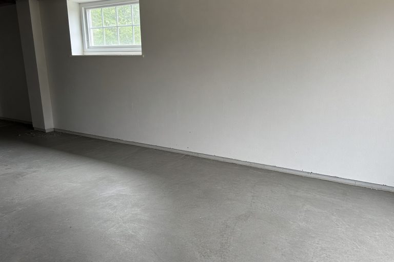 Dry repaired basement floor meeting a straight wall — Basements in Wheeler