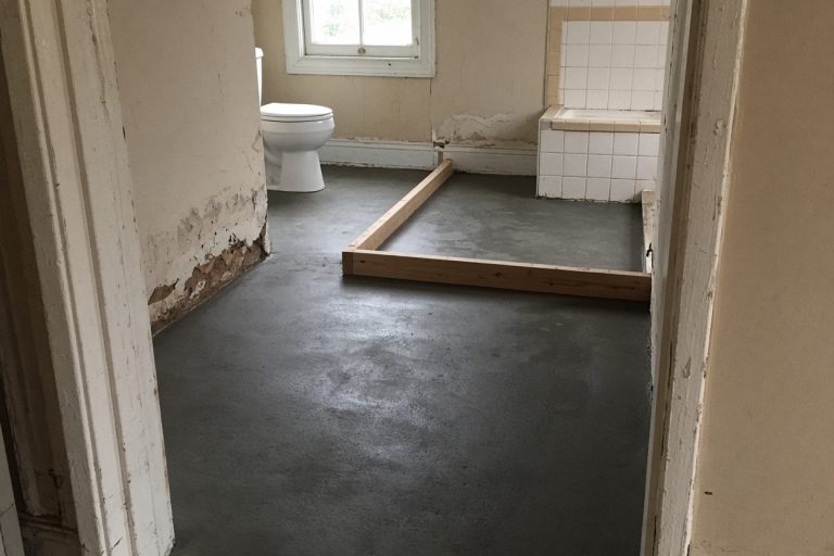 Fresh bathroom floor and shower curb after the pour - Bathroom Remodeling in Chesterton