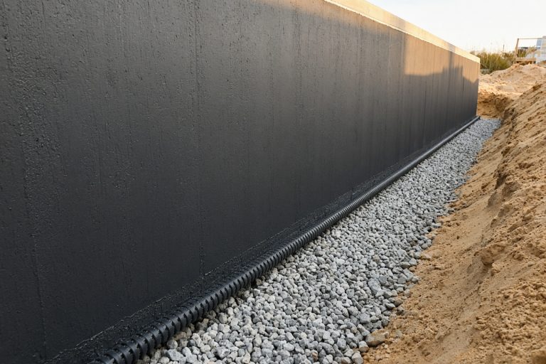 Coated basement wall with drain tile at the footing — Concrete Basements in Burns Harbor