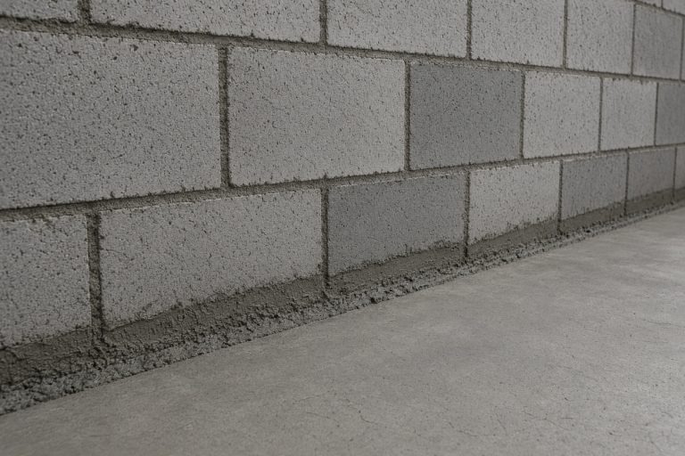 Repaired joint where basement floor meets block wall: Concrete Basements in South Holland