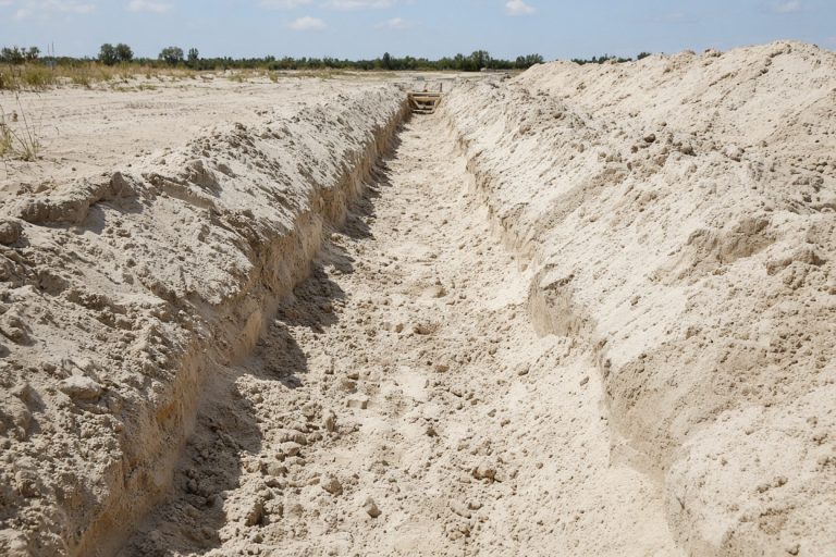 Open footing trench with caved sand edges — Concrete Foundations in Michigan City