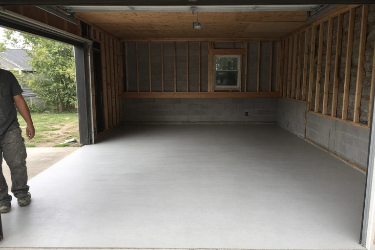 Smooth finished slab in a detached garage with the door open - Concrete Garage Floors in Gary