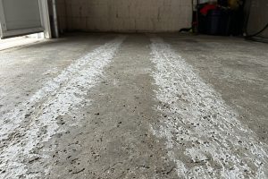 Pitted concrete in tire tracks inside a home garage, Concrete Garage Floors in Lake Station