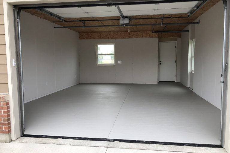 Smooth new garage slab inside an open residential garage - Concrete Garage Floors in Michigan City