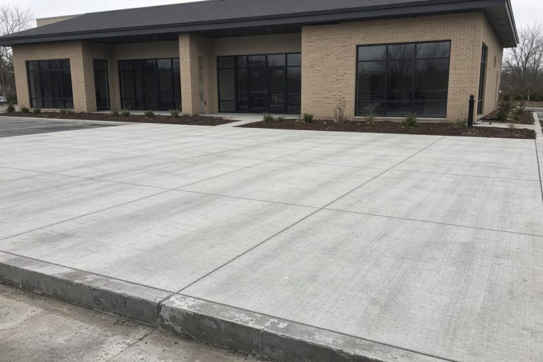 Finished storefront lot with clean joints and a curb — Concrete Parking Lots in Calumet City