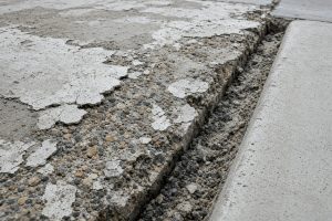 Scaled concrete and an open joint beside a curb, Concrete Parking Lots in Crown Point