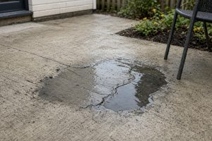 Low spot holding water on an older backyard slab - Concrete Patios in Hobart