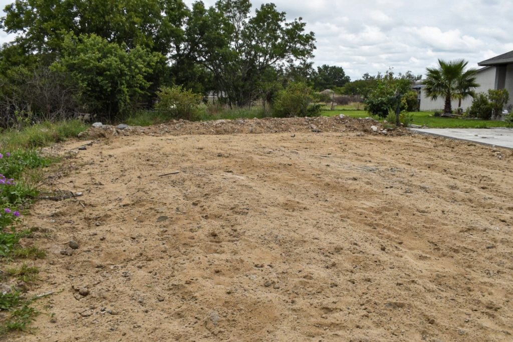 Bare sandy yard after an old slab was hauled out — Concrete Removal in Porter