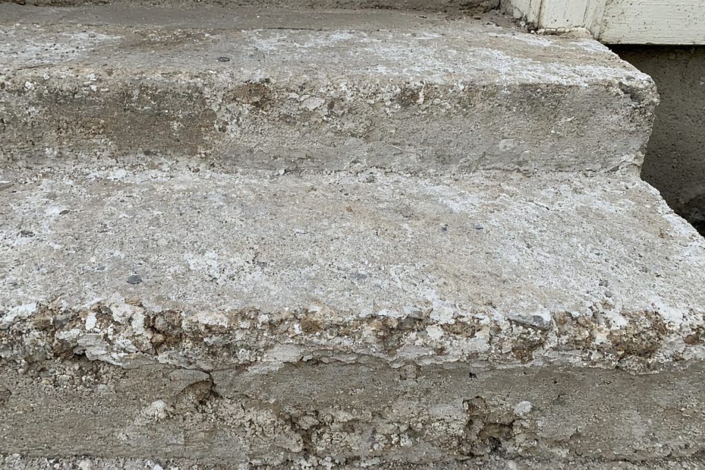 Salt-scaled porch step treads with chipped nosings — Concrete Steps in Gary