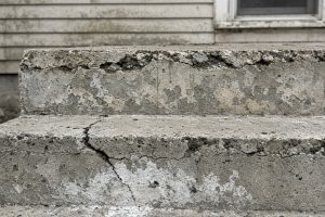 Scaled treads and a cracked nosing on an old poured stoop, Concrete Steps in Hammond
