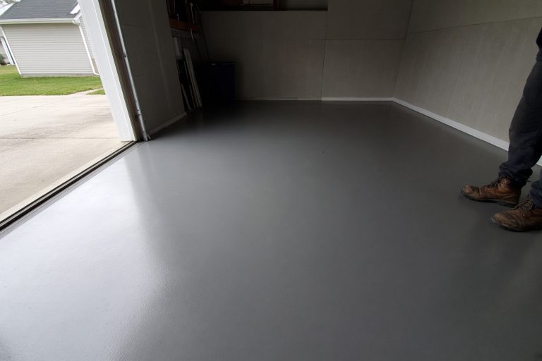 Glossy coated garage floor with a clean tire path - Epoxy Flooring in Dyer