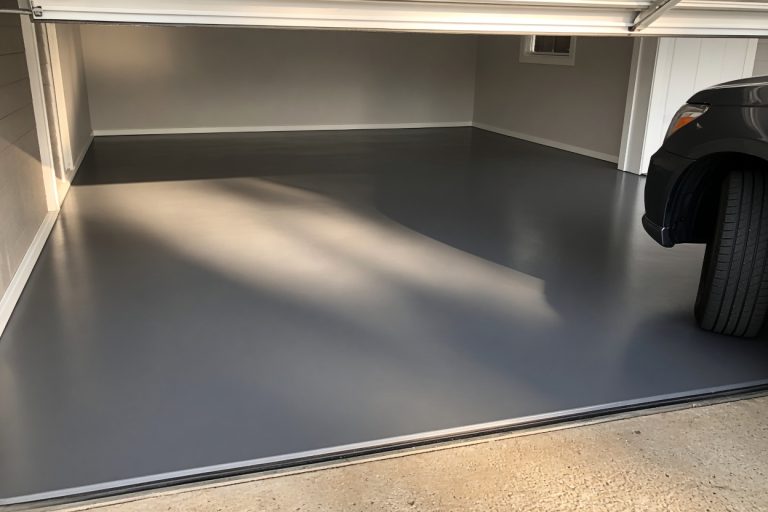 Finished epoxy garage floor with a tire at the edge — Epoxy Flooring in South Haven