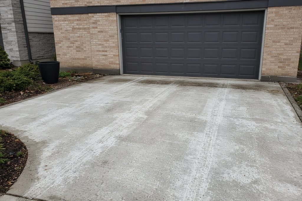Salt-stained tire tracks on a residential garage slab — Garage Floors in Valparaiso