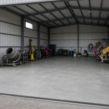 Open farm workshop with a new gray slab and equipment along the walls — Concrete Slabs in Kouts