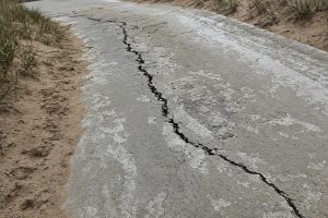 Salt-scaled crack on a sloping driveway — Concrete Driveways in Ogden Dunes