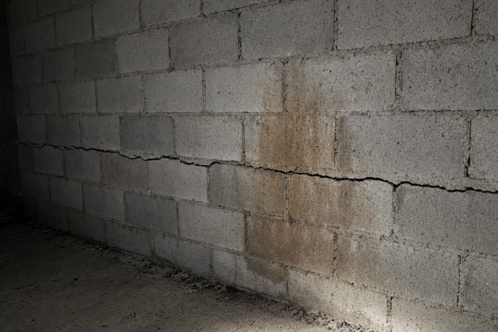 Horizontal crack and water stain on a block basement wall — Concrete Basements in Portage