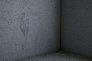 Water beads on a gray basement wall — Concrete Basements in Porter