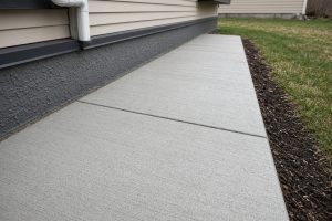 Patio edge sloped away from a house foundation — Concrete Patios in Wheeler
